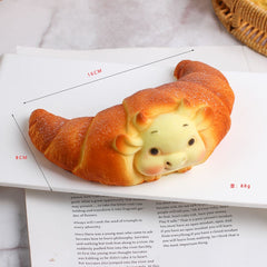 Juguete sensorial blando de crecimiento lento con forma de croissant de ganado, con un tacto súper suave y un juguete premium para aliviar el estrés.